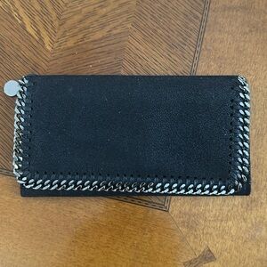 Never used Stella McCartney wallet in black with silver chain trim holds plenty